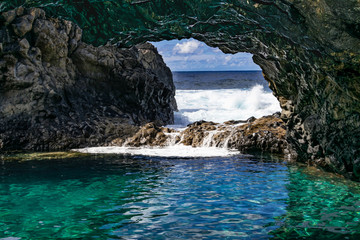 Charco azul volcanic cavern, natural volcanic ocean pool with turquoise ocean water in a volcanic...