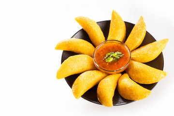 Colombian empanada with spicy sauce