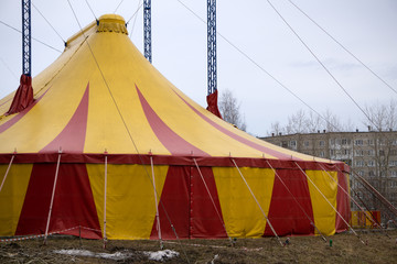 Colourful circus tent against a blue sky .
