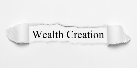 Wealth Creation on white torn paper