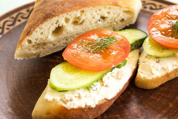 Vegetarian sandwiches with cream cheese, cucumbers and tomatoes, healthy snack.