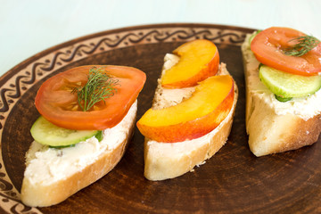 Vegetarian sandwiches with cream cheese, cucumbers and tomatoes, healthy snack.