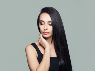 Young perfect woman with long dark straight hair and makeup portrait