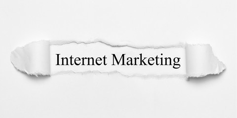Internet Marketing on white torn paper