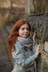 Portrait of a beautiful pensive girl with red hair and freckles.