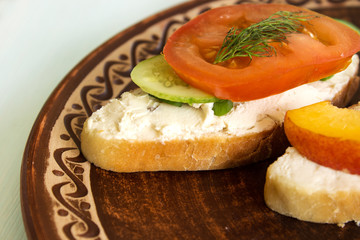 Vegetarian sandwiches with cream cheese, cucumbers and tomatoes, healthy snack.