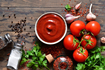 Tomato ketchup sauce with spices and pepper. View from above.