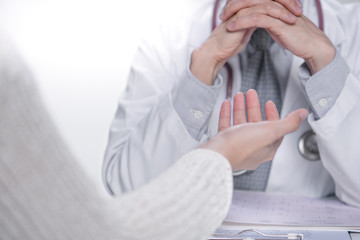 Fototapeta premium Medical doctor and patient discussing and consulting in hospital examination room