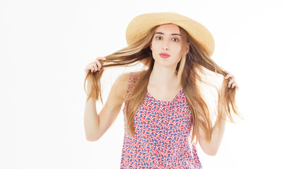 fashion and lifestyle concept - beautiful woman in hat holding her hair curles enjoying summer outdoors isolated on white.