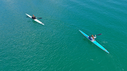 Aerial drone photo of women competing in sport canoe in calm water lake