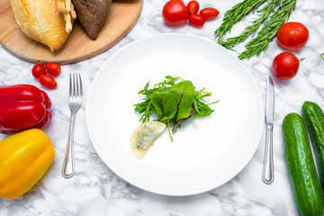 Dumplings, filled with cabbage. vegetable dumplings. Dumplings with potatoes in plate on white background. Ingredients for dumplings with cabbage, potatoes, tomato, cucumber, lettuce, pepper. Top vie