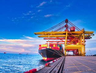 Containers are discharging from vessel by truck in port of Thailand