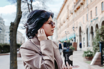 Obraz premium Portrait of successful businesswoman holding cup of coffee In hand on her way to work