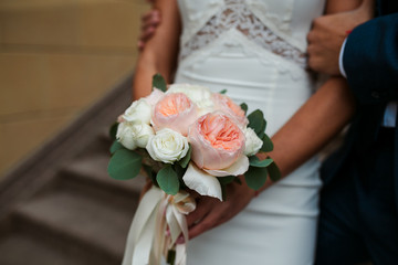 bouquet of flowers in the hands of the bride