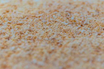 Texture of bread crumb, side view. Abstract golden crumbs background, closeup.