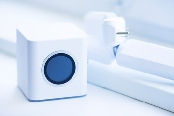 Wifi business concept. Wifi router, access points, mobile phone, laptop, camera and other wireless endpoints on the white background. Closeup. Space for a text.