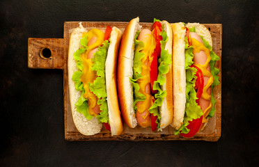 delicious hot dogs on a cutting board against a background of stone
