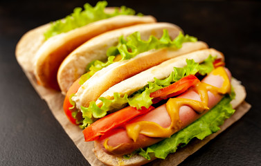 delicious hot dogs on a cutting board against a background of stone