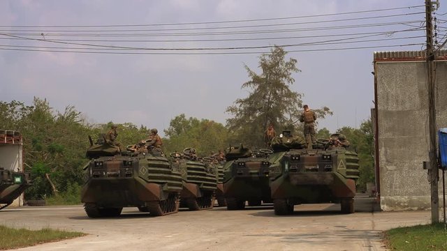 Soldiers standing on AAV7 Amphibious Vehicles