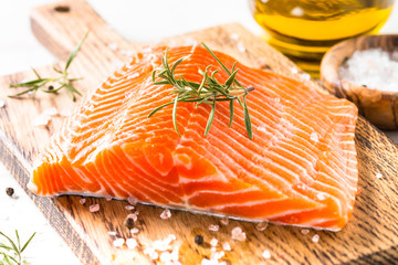 Fresh fish salmon with lemon sea salt and rosemary on white.