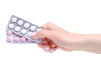 Blister pills in hand on white background isolation. Pharmacy and medicine concept