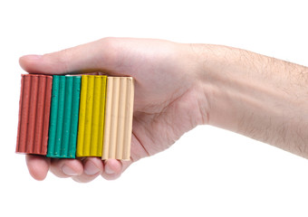 Plasticine in hand on white background isolation