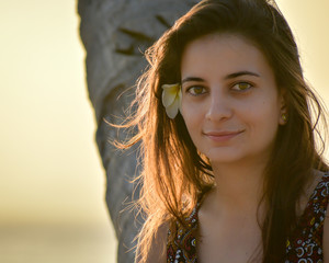 Close-up of a young girl with a flower on her ear