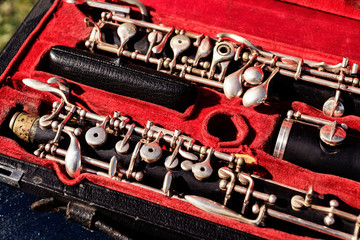 Musical wind instrument oboe in original red case.