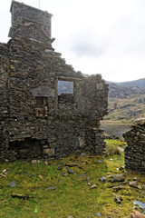Ruins of a stone house on the Cwmorthin Waterfall trail in the mountains of Snowdonia National Park, Wales.