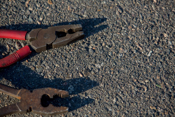 Different tools on a background of asphalt closeup
