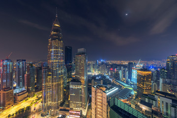 Fototapeta na wymiar Beautiful night scene of iconic Kuala Lumpur landmark, aerial view illuminated by city light, cityscape landscape.