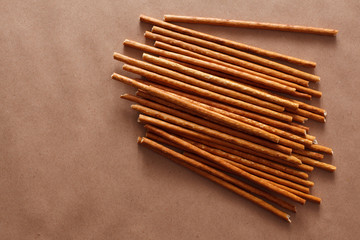 Crispy bread straw on brown paper background