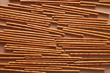 Crispy bread straw on brown paper background