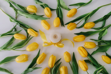A frame of  tulips on white background. Flat lay, top view. Concept of holiday, birthday, Easter, March 8. 
