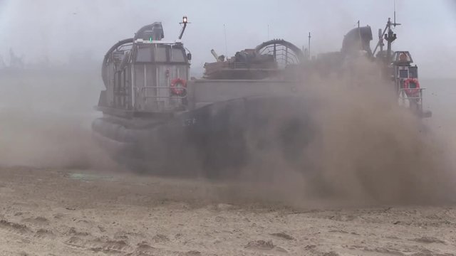 LCAC Military hovercraft settling on the beach