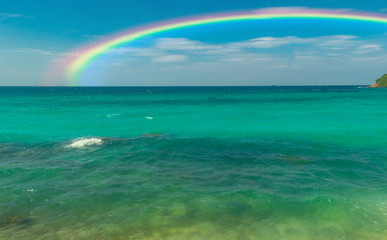 Beach and rainbow, beautiful colors in the blue sky 