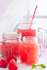 Kissel from frozen strawberries in glass jars, selective focus