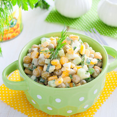 Bright salad with peas and corn in a colored bowl, square