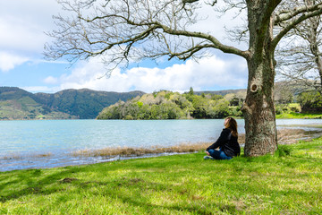 Girl looking over Sete Cidades lake into the mountains, Azores, Portugal.