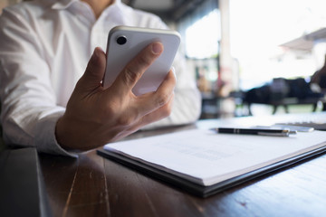 Close up of a man using mobile smart phone on the table