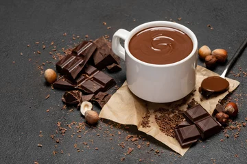 Rolgordijnen Cup of hot chocolate and pieces of chocolat on dark concrete background © Anatoly Repin