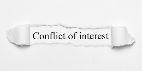 Conflict of interest on white torn paper