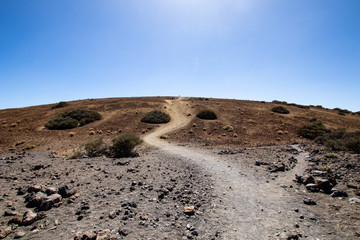 mountain desert with volcanic rocks, panorama of a rocky desert with red earth and sand