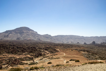 mountain desert with volcanic rocks, panorama of a rocky desert with red earth and sand