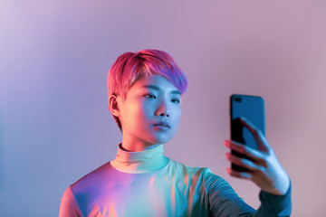 Creative shot of young adult female taking selfie