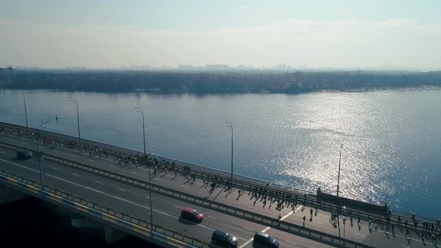 Marathon running on the bridge. Dolly shot