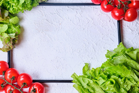 Frame For Copy Space With Lettuce, Cucumbers, Pepper And Cherry Tomatoes On A White Background