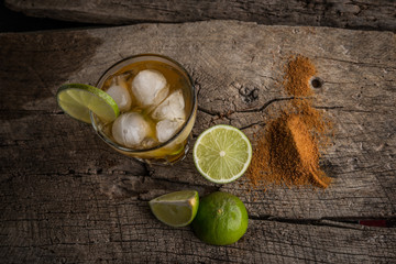 Caipirinha of Brazil with cinnamon over rustic wood