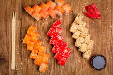 Set sushi rolls on a wooden table with tents soy sauce and ginger. Tasty dinner. Ukrainian inerpretation for Japanis kitchen