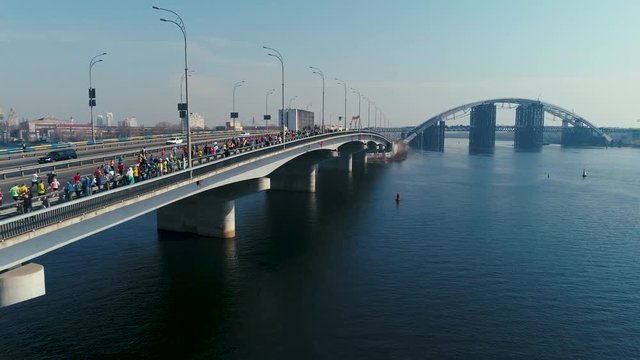 Marathon running on the bridge. Dolly shot